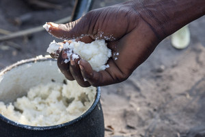 Maize porridge in hand and in cooking pot, Botswana