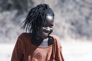 African girl laughing in red sweater, Botswana