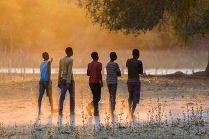 Group of youths walking in evening light, Botswana