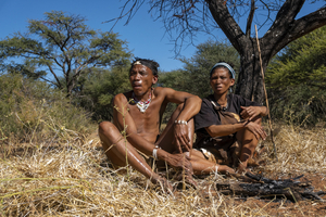 Bushman and woman in Kalahari making fire, San, Botswana