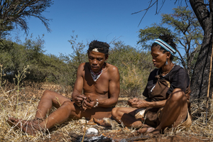 Bushman and woman in Kalahari making fire, San, Botswana