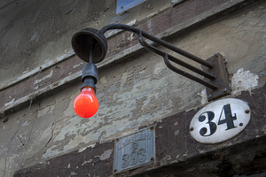 Red lamp on old house wall, Dresden, Germany