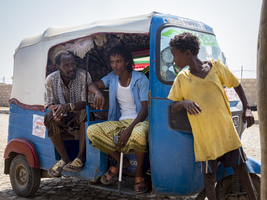 Rickshaw and rickshaw driver talking, Ethiopia, Africa