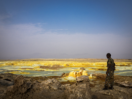 Soldier, geothermal area with sulfur deposits and acidic salt paints, Dallol, Danakil Depression, Ethiopia, Africa