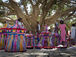 Market with colorful baskets under tree, Ethiopia, Africa