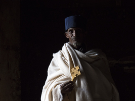 / Priest with cross in dark light, Gondar, Amhara Region, Ethiopia, Africa