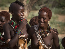 Young women from the Hamar tribe with necklaces and body jewelry