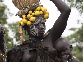 Woman with toddler and headdress from the Mursi tribe, Ethiopia, Africa