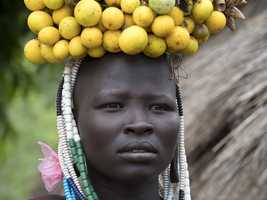 Woman from the Mursi tribe with yellow headdress, portrait, Ethiopia, Africa