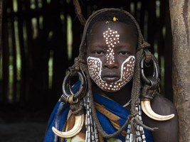 Boy from the Mursi tribe with headdress and face-paint, portrait, Ethiopia, Africa