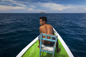 Man at bow on small boat, Flores, Indonesia