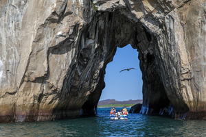 Boat between rocks grotto, Galápagos Islands
