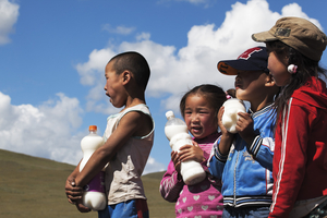 Children with milk bottles in hand, mare's milk, Mongolia