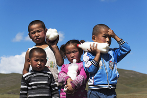 Children with milk bottles in hand, mare's milk, Mongolia