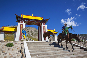 Rider with horse on stairs at temple, Mongolia