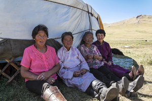 Mongolian women sit in front of yurt in the shade, Mongolia
