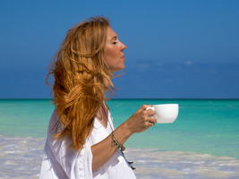 Woman with red hair on the beach, cup of tea, Ambatomilo, Madagascar