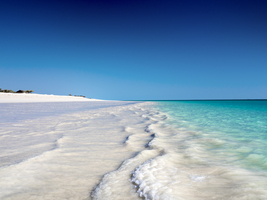 Long white beach, gentle waves, turquoise sea, Ambatomilo, Madagascar