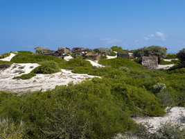 Huts village, sand dunes and green bushes, west coast, Madagascar