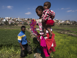 Young family with child in the rice field, Ambohimanarina, Antananarivo, Madagascar
