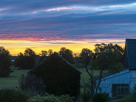 Sonnenaufgang am Dorfrand, altes Bauernhaus, weite Wiesen, bunter Himmel, Schlepzig, Spreewald, Brandenburg, Deutschland