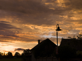 Bunter Sonnenaufgang mit Wolkenfärbung, Laterne und altes Bauernhaus, Spreewald, Brandenburg, Deutschland