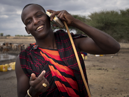 Young Maasai talking on an old cell phone, Tanzania