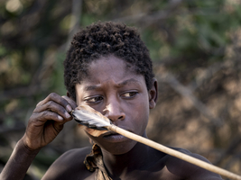 Bushman boy with arrow and serious look, portrait, Tanzania
