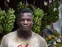 Young man, banana seller, serious look, striking face, portrait, Tanzania