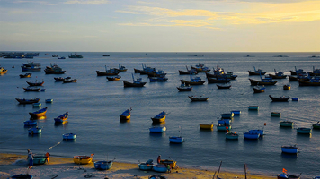 Fishing boats and basket boats in Mui Ne bay, Vietnam