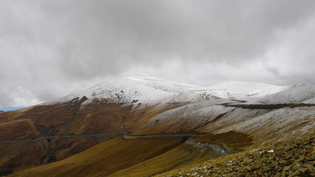 Kampala pass landscape with road and snow covered mountains, Tibet