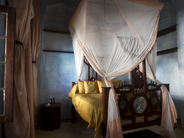 Old luxury room with yellow four poster bed, Emerson Spice Hotel, Zanzibar