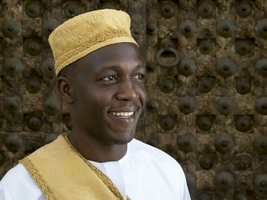 Arab man with yellow cap at reception, Zanzibar