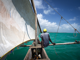 Man on small old sailing boat, Ngalawa boat, Zanzibar