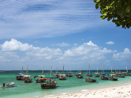 Boats on the white beach in the turquoise sea, Kwale Island, Zanzibar, Tanzania